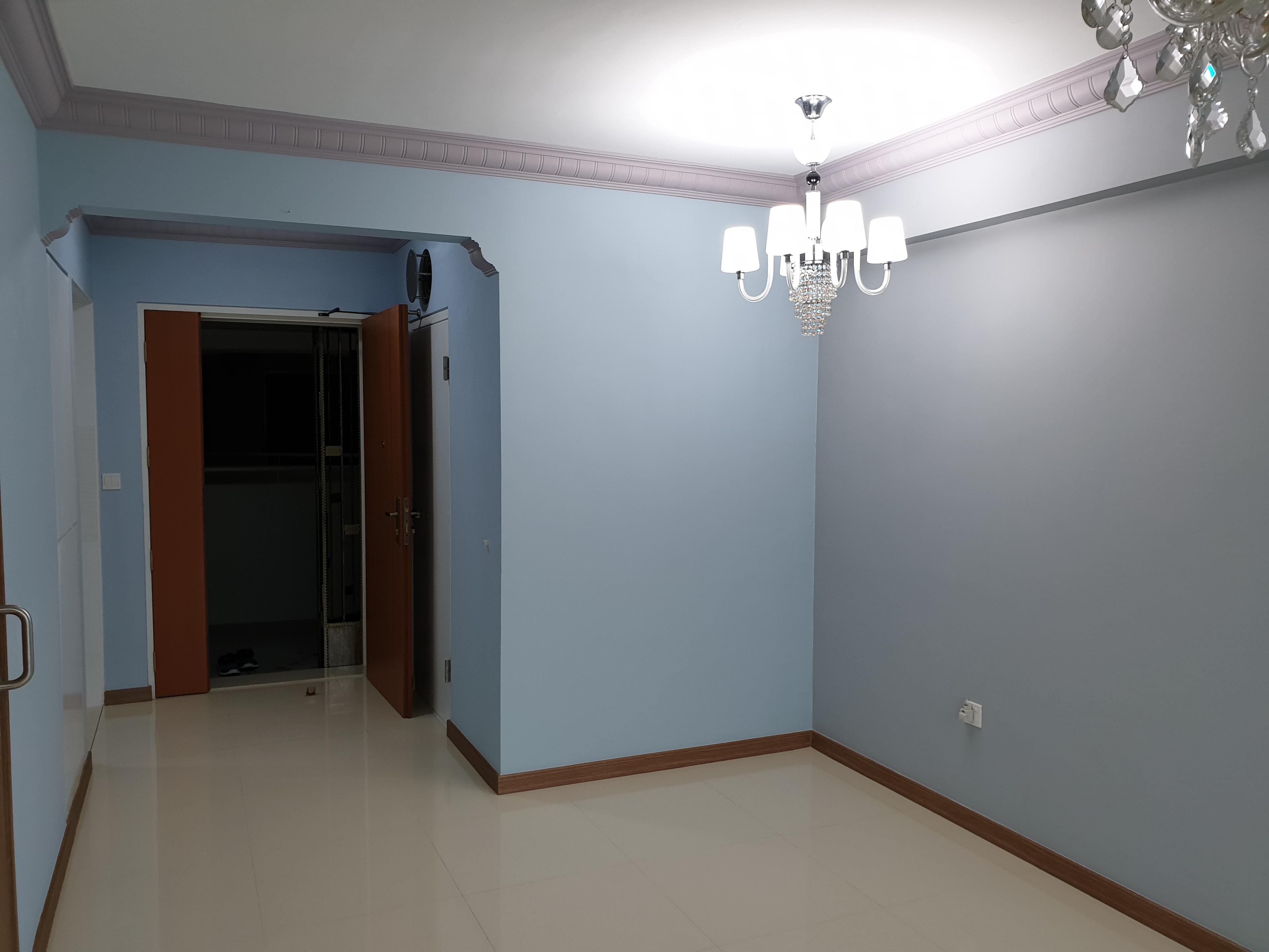 Hallway with chandelier and bedroom door