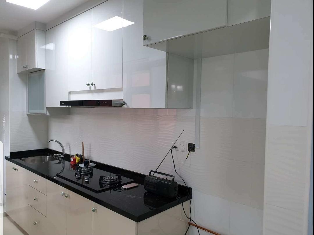 Kitchen with white cabinetry and black countertop