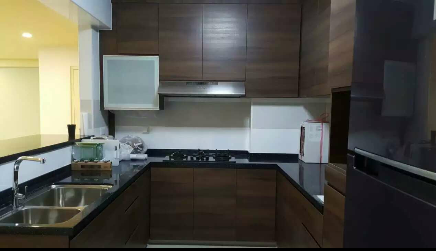 Kitchen with dark wood cabinetry and cooker hood