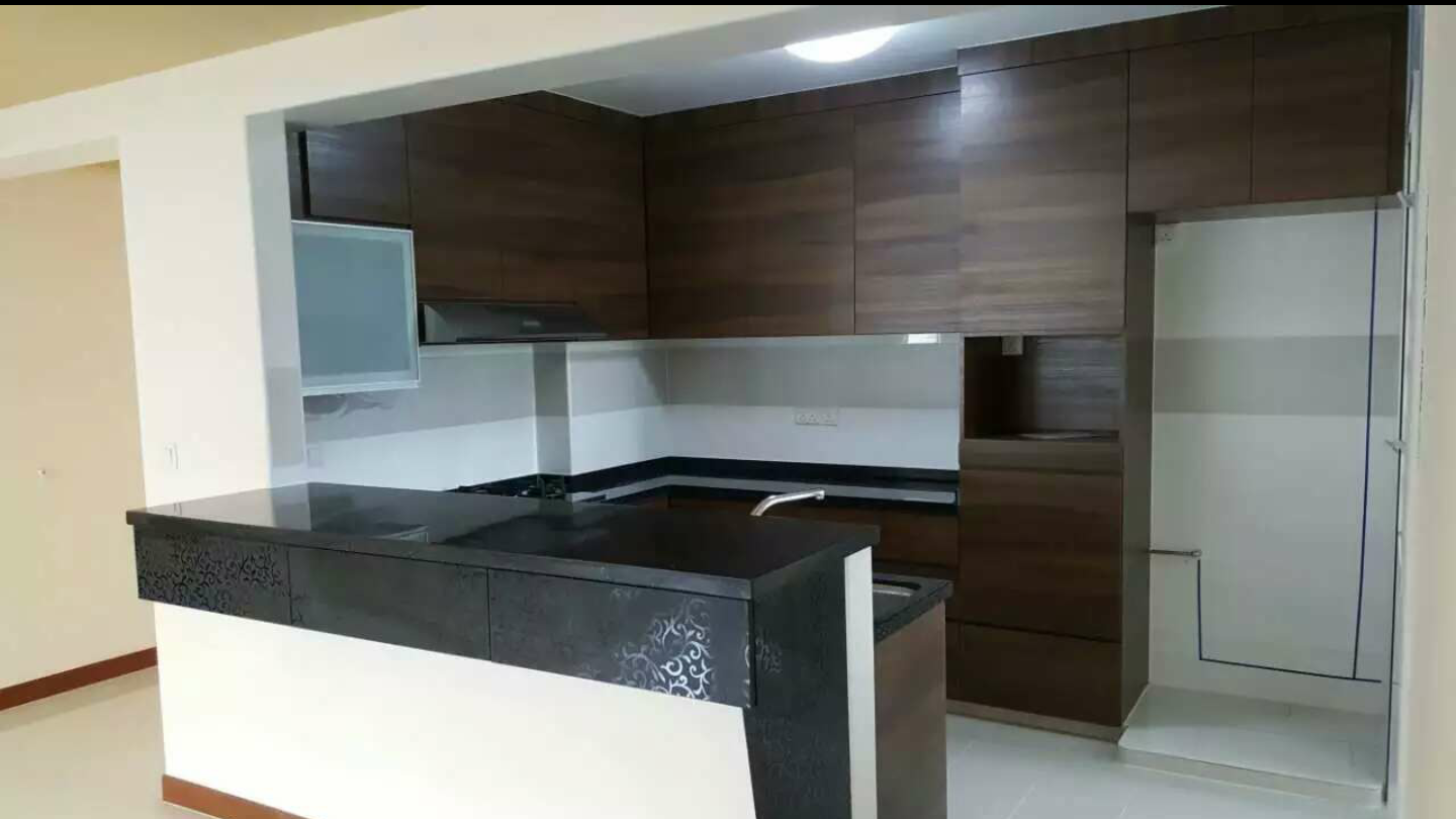 Kitchen with walnut cabinetry and window