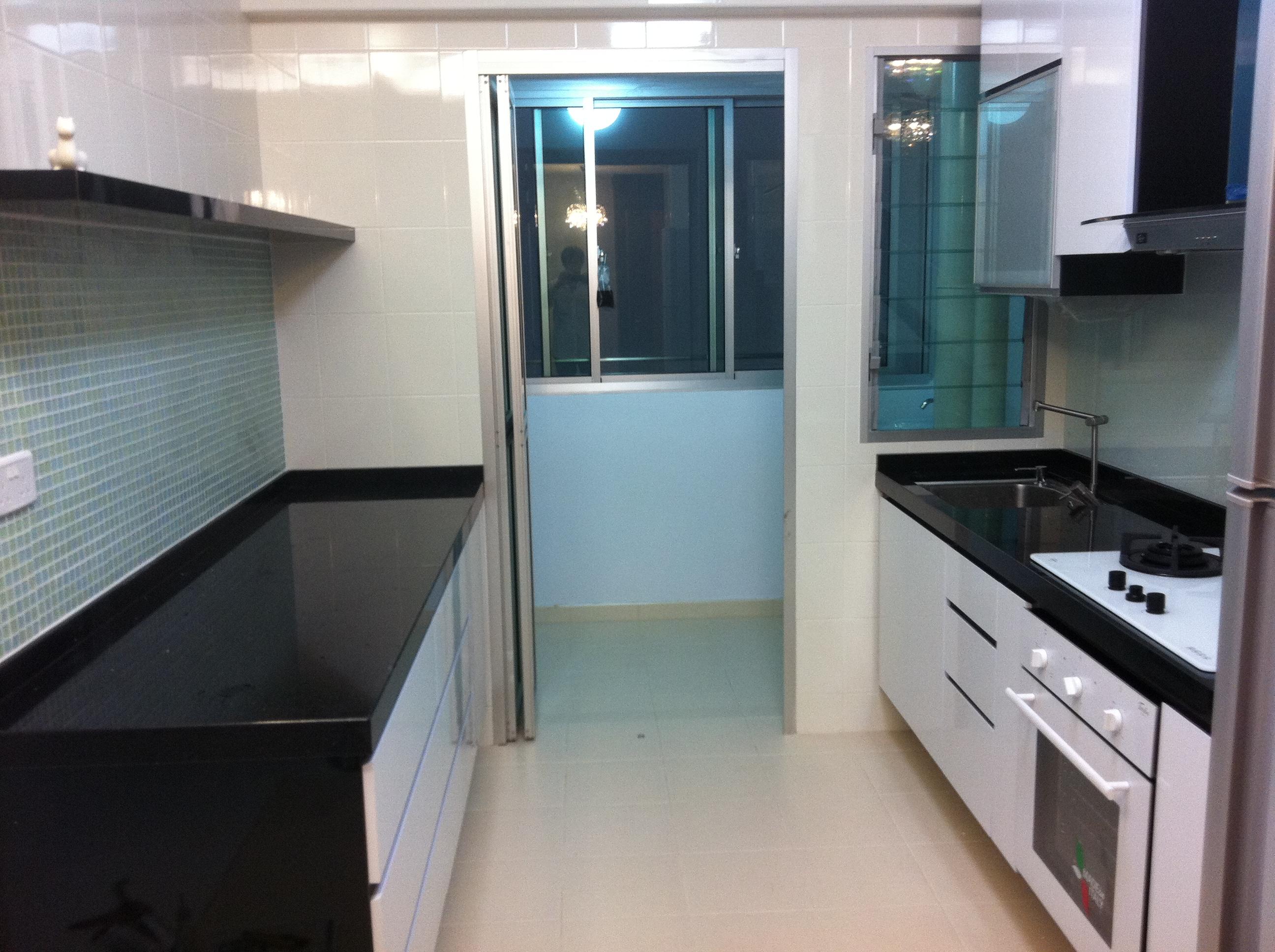 Kitchen with tiled backsplash and balcony door
