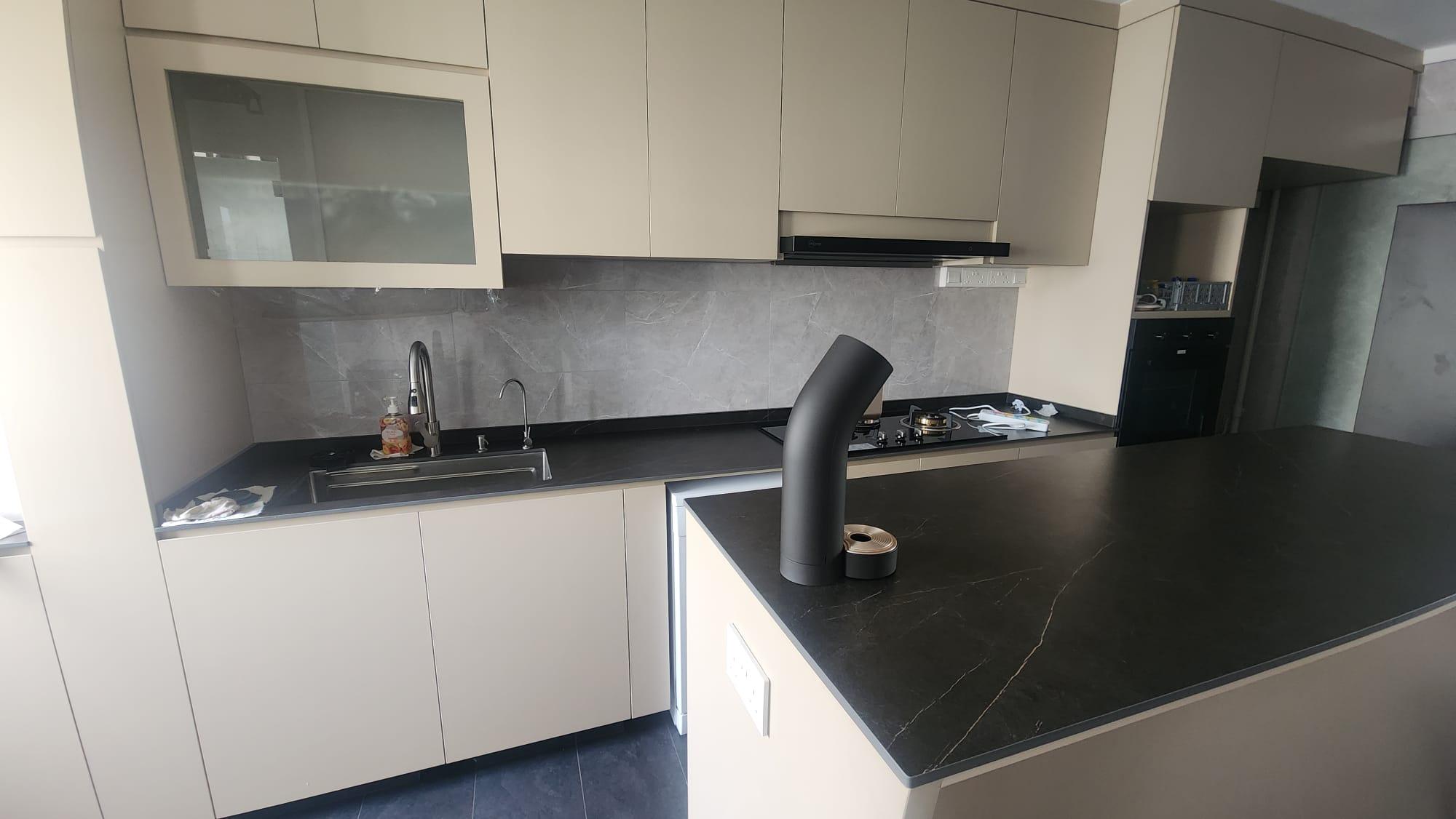 Hallway leading to white kitchen with island