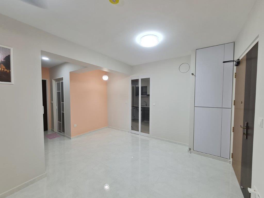 Living area with mirrored doors and peach wall