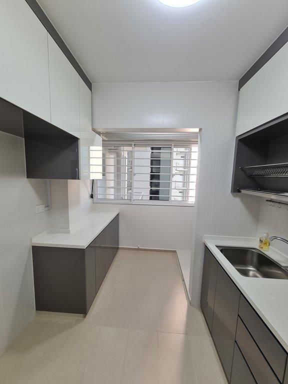 Galley kitchen with white cabinetry
