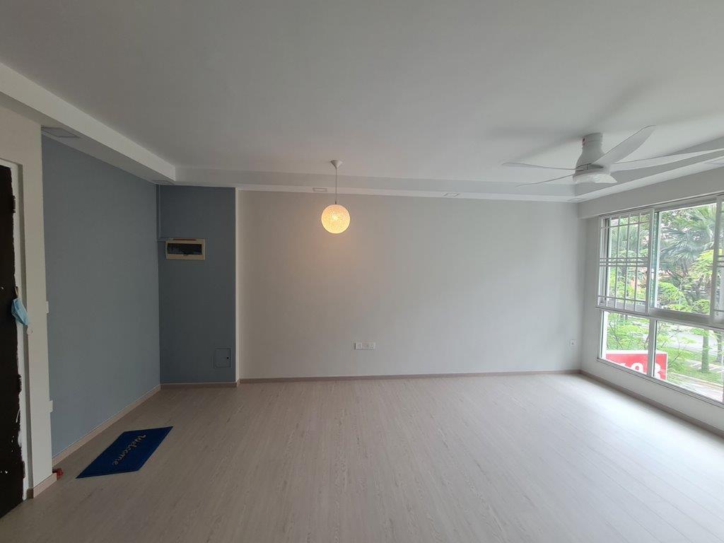 Living room with blue accent wall and vinyl flooring