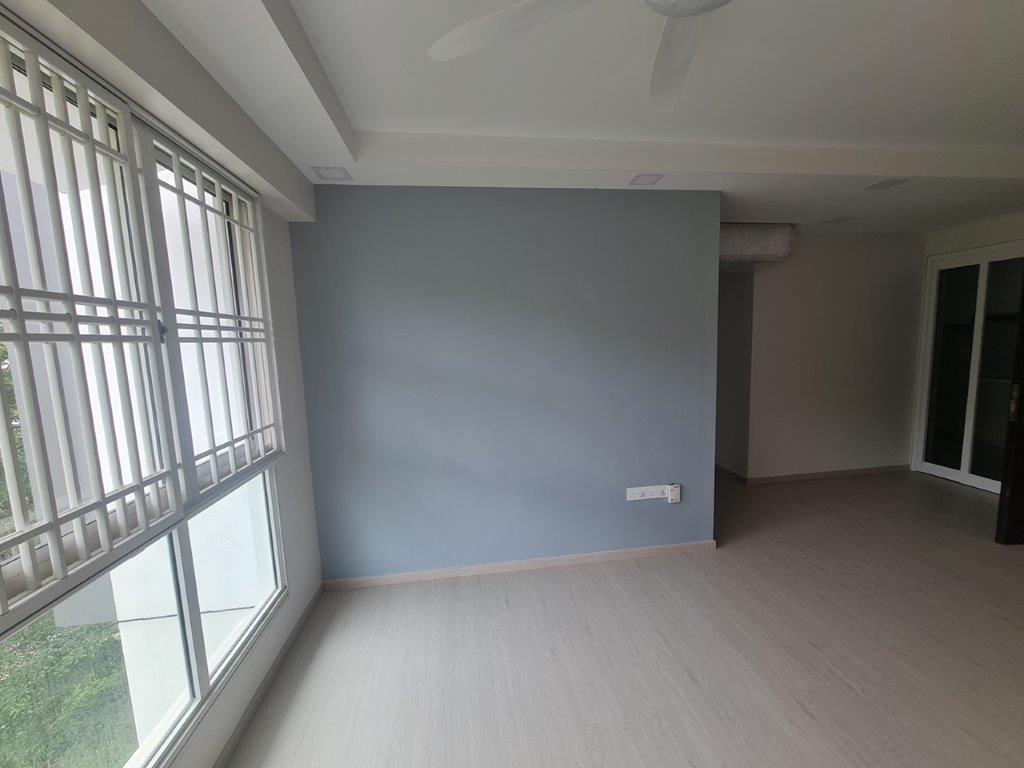 Living room blue feature wall by window