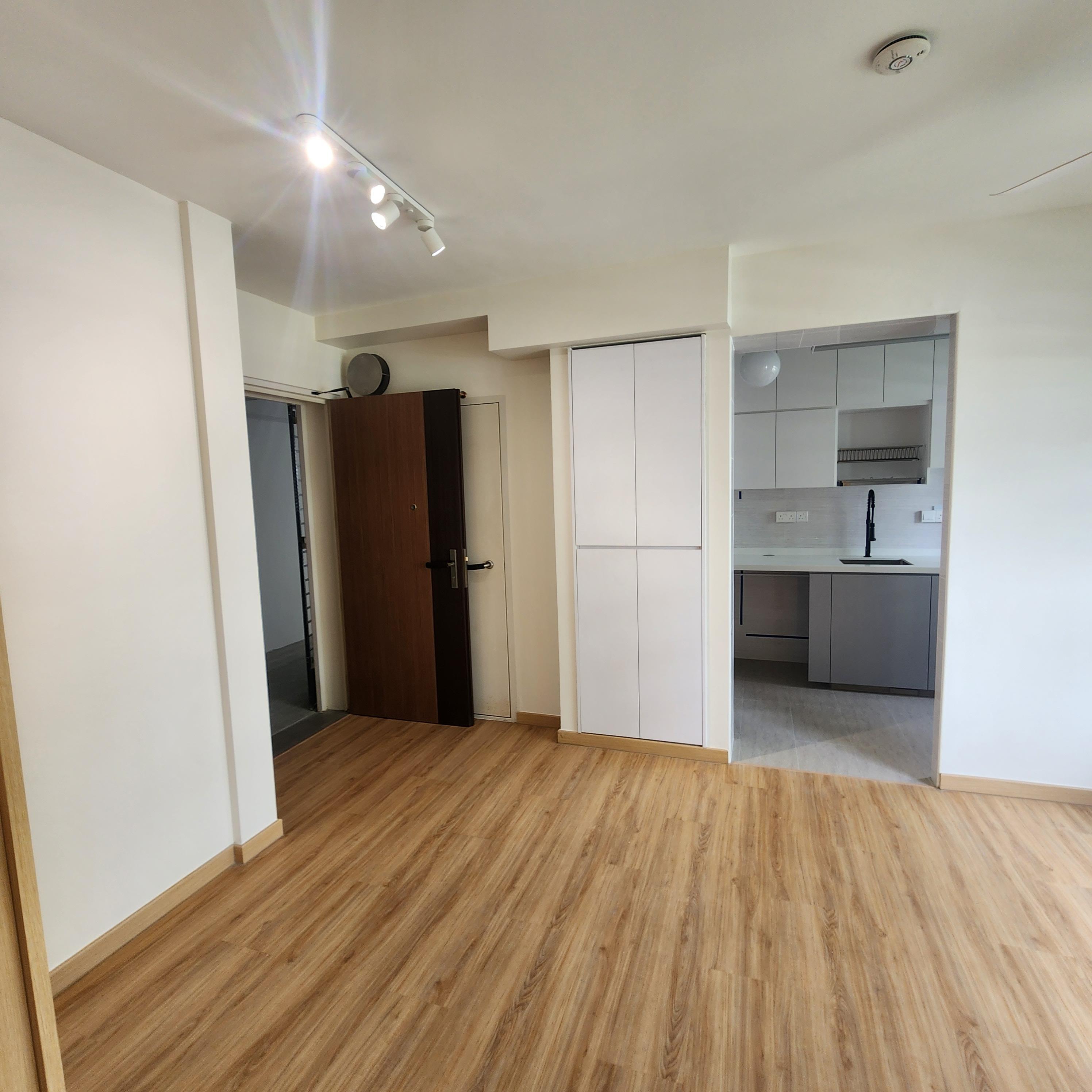 Living area with wardrobe and kitchen view