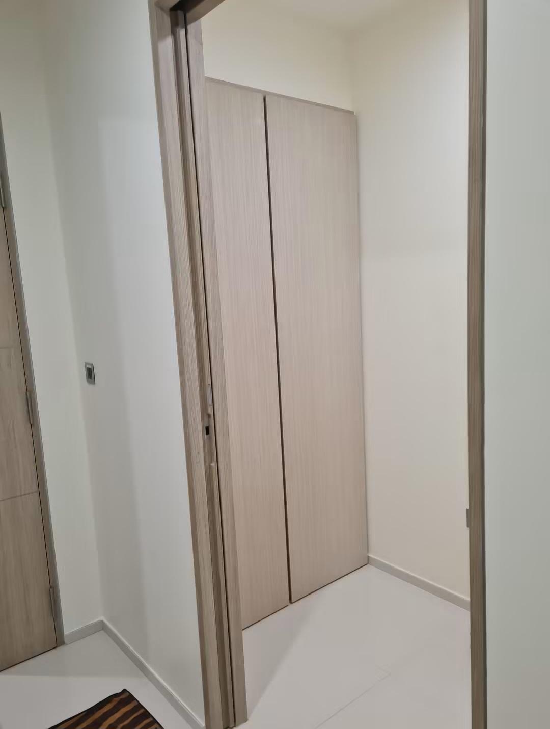 Hallway with built-in wardrobe and warm lighting