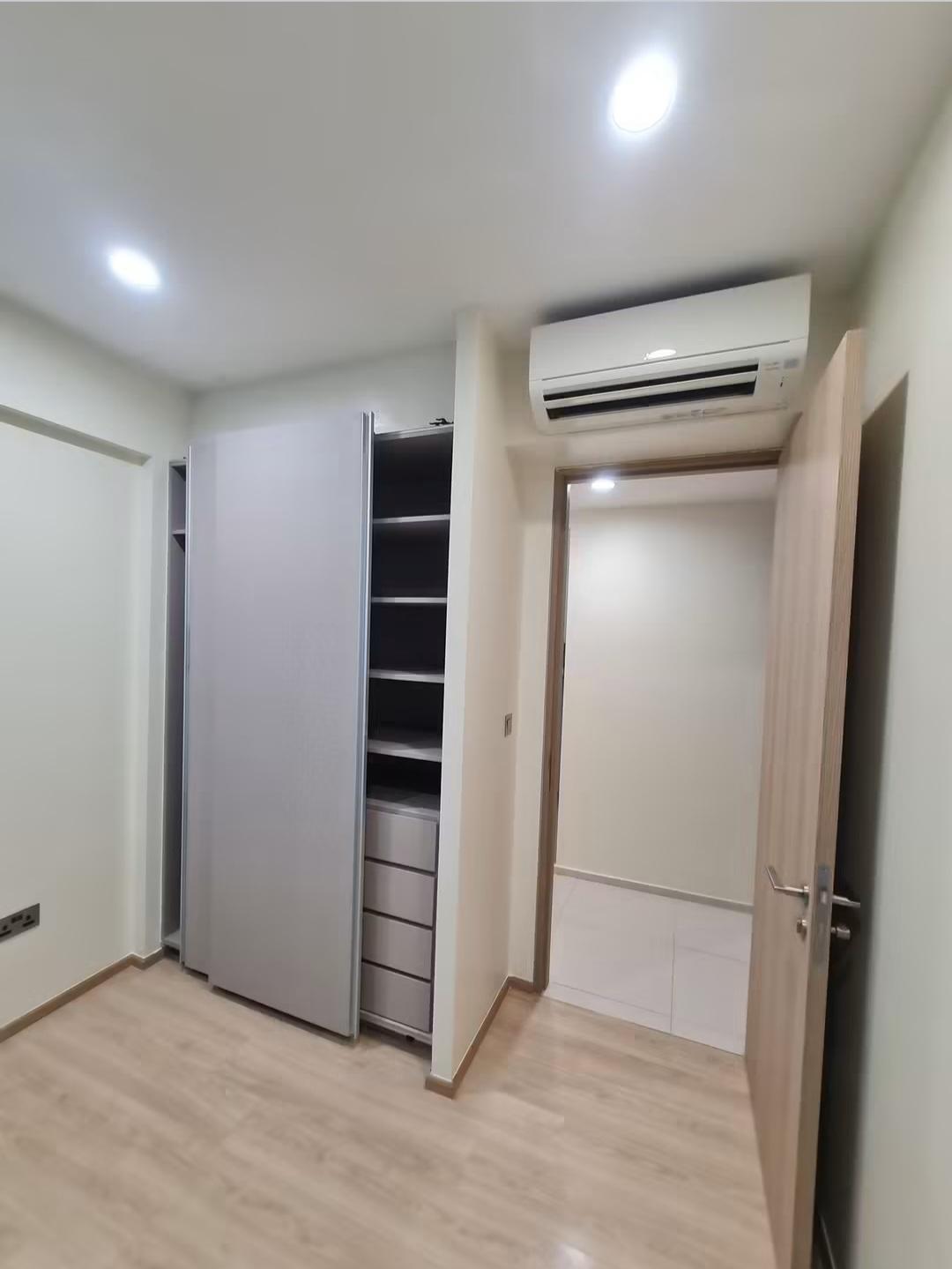 Bedroom wardrobe with drawers and hallway view