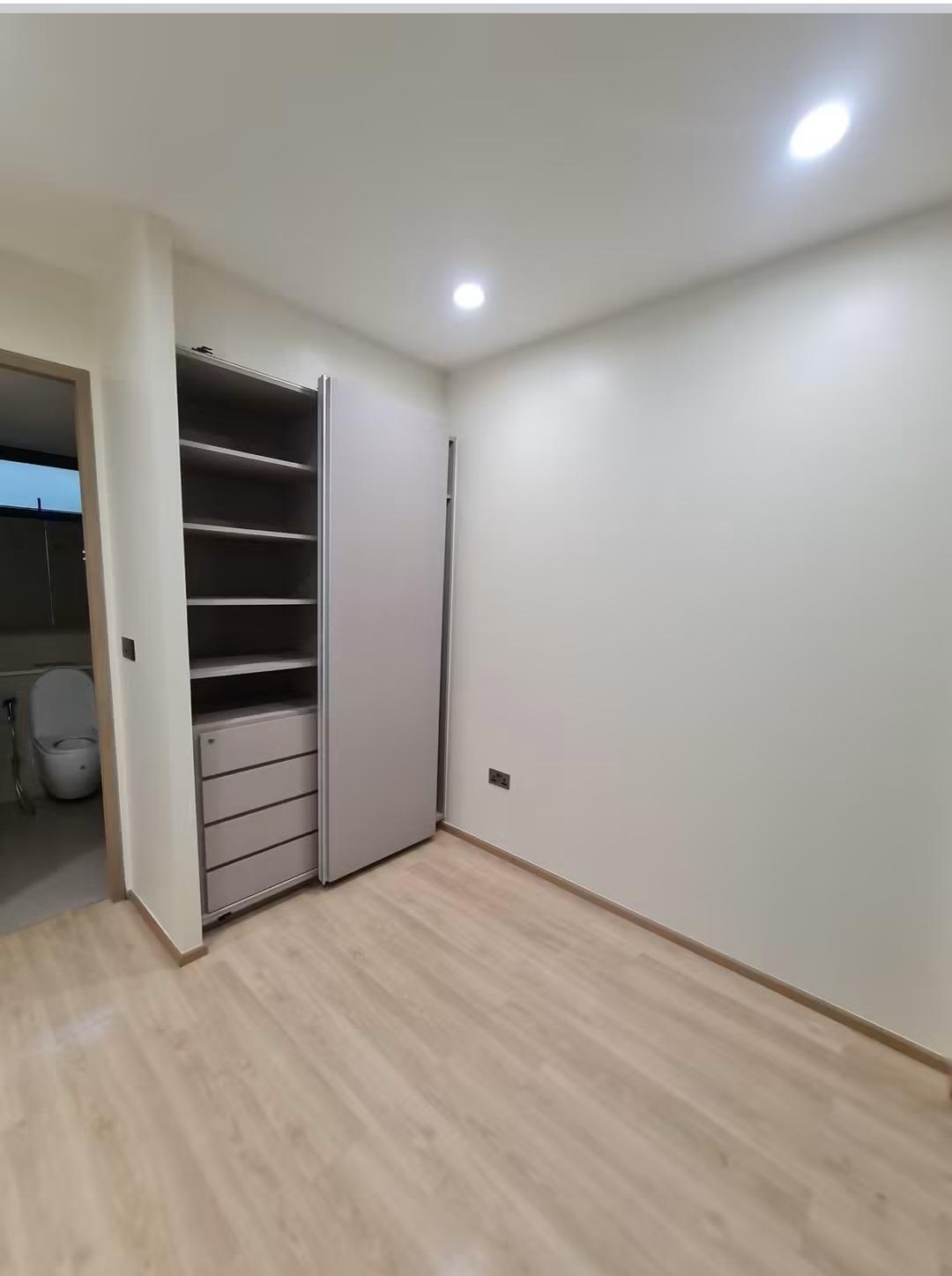 Bedroom wardrobe with hanging rail, ensuite in view