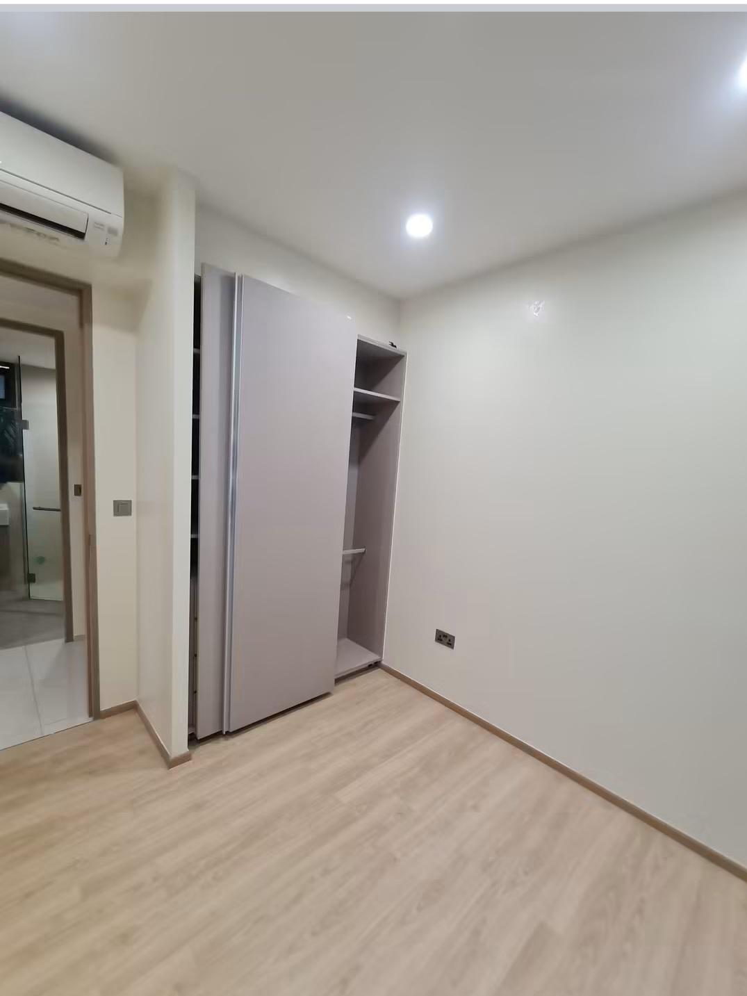 Bedroom with open wardrobe and air-conditioning