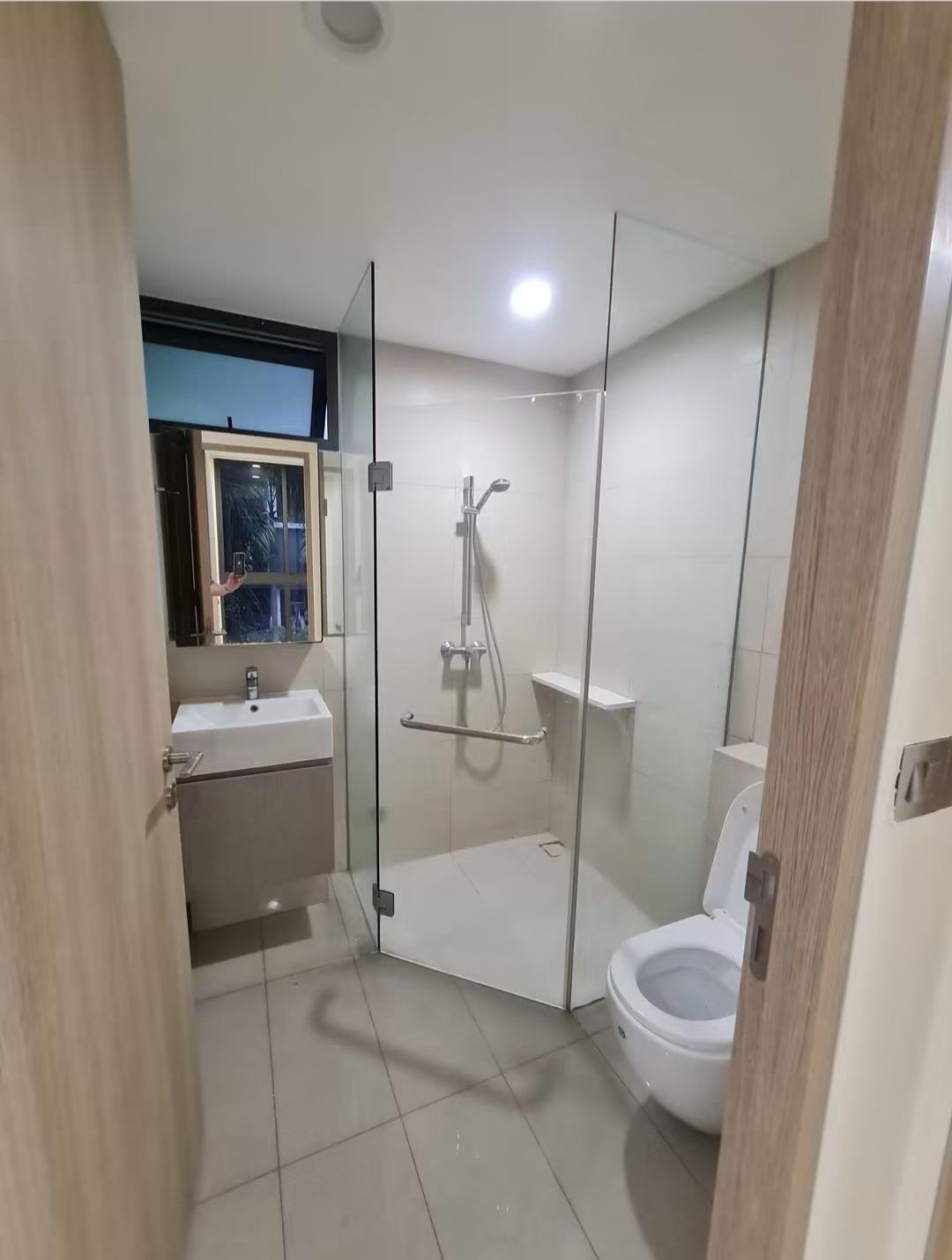 Bathroom with glass shower enclosure and toilet